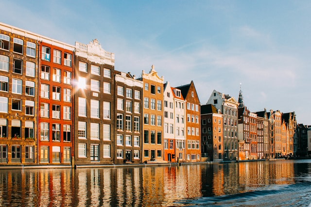 a canal in Amsterdam lined with traditional, colourful Dutch houses